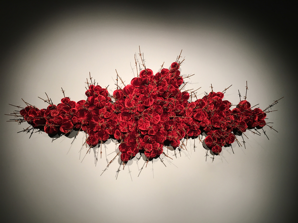 Strange Fruit 2018; reclaimed military barbed wire, silk velvet Strange Fruit 2018; reclaimed military barbed wire, silk velvet