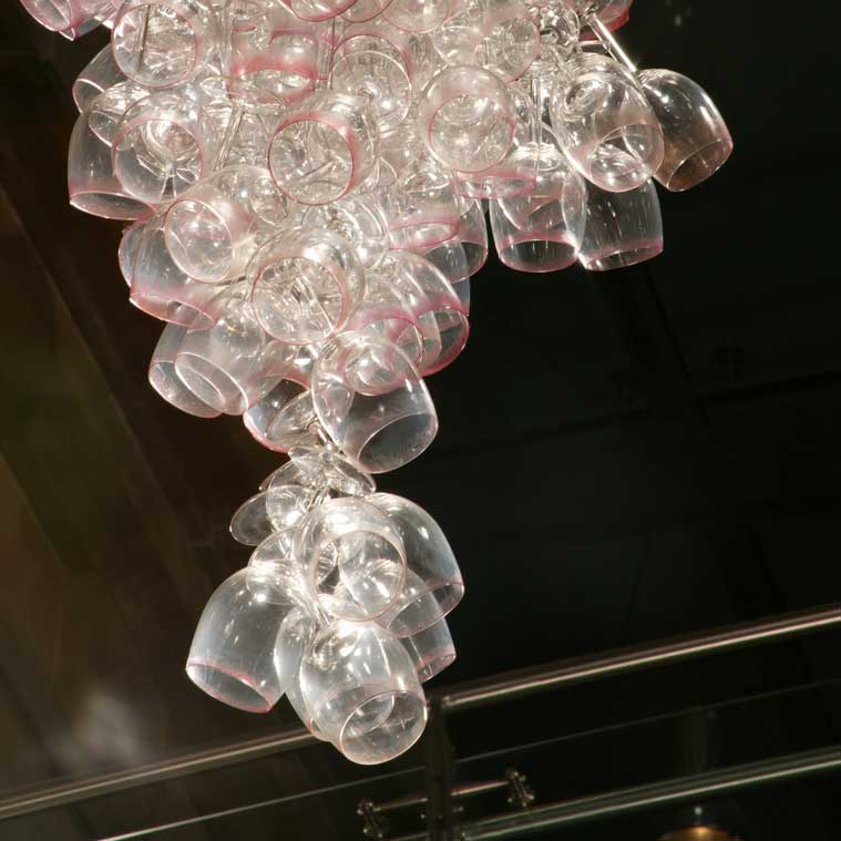 Here Come the Girls 2009

Manchester Art Gallery Atrium

1100 Wine Glasses

Lipstick

Commissioned by Manchester Art Gallery to celebrate the festive season and specifically to link to their exhibition Angels of Anarchy: Women Artists and Surrealism.  The primary reference is to Meret Oppenheim's iconic fur teacup, saucer and spoon, Object.  In a contemporary culture where women are just as likely to drink wine as tea the vessel still functions as a metaphor for the female body, but in the 21st century sexual politics have evolved.

Each glass is individually rimmed with lipstick using the artist's lips.  Cosmetics, particularly lipstick, are often advertised as a way to enhance feminine power and choice, and one cosmetic company even used the slogan 'It's not makeup, it's ammunition'.

<em>"While thinking of 'strong women' femininity, power and Christmastime, I was reminded of the recent Boots TV commercials with crowds of women getting glammed up and marching out to celebrate to the Sugababes 'Here come the Girls'."</em>  Susie MacMurray

The work offers a space for rumination on the evolution of feminism and perceptions of female power/empowerment in it's various guises – cultural/political/sexual.  Also on the different ways women choose to exercise that empowerment (including binge drinking), the ambiguities it throws up, and psychological bargains we strike with ourselves.