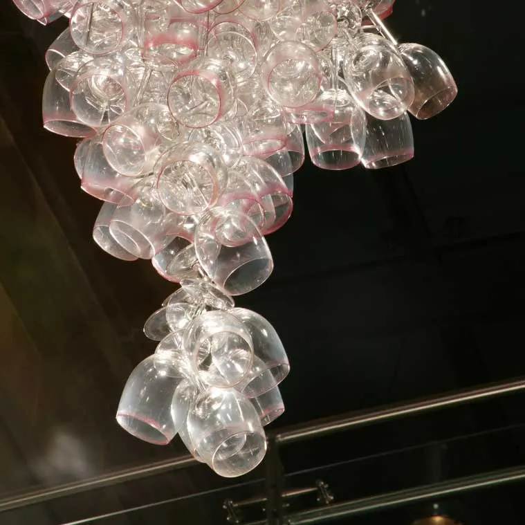 Here Come the Girls 2009

Manchester Art Gallery Atrium

1100 Wine Glasses

Lipstick

Commissioned by Manchester Art Gallery to celebrate the festive season and specifically to link to their exhibition Angels of Anarchy: Women Artists and Surrealism.  The primary reference is to Meret Oppenheim's iconic fur teacup, saucer and spoon, Object.  In a contemporary culture where women are just as likely to drink wine as tea the vessel still functions as a metaphor for the female body, but in the 21st century sexual politics have evolved.

Each glass is individually rimmed with lipstick using the artist's lips.  Cosmetics, particularly lipstick, are often advertised as a way to enhance feminine power and choice, and one cosmetic company even used the slogan 'It's not makeup, it's ammunition'.

<em>"While thinking of 'strong women' femininity, power and Christmastime, I was reminded of the recent Boots TV commercials with crowds of women getting glammed up and marching out to celebrate to the Sugababes 'Here come the Girls'."</em>  Susie MacMurray

The work offers a space for rumination on the evolution of feminism and perceptions of female power/empowerment in it's various guises – cultural/political/sexual.  Also on the different ways women choose to exercise that empowerment (including binge drinking), the ambiguities it throws up, and psychological bargains we strike with ourselves.