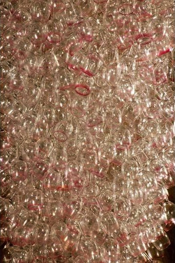 Here Come the Girls 2009

Manchester Art Gallery Atrium

1100 Wine Glasses

Lipstick

Commissioned by Manchester Art Gallery to celebrate the festive season and specifically to link to their exhibition Angels of Anarchy: Women Artists and Surrealism.  The primary reference is to Meret Oppenheim's iconic fur teacup, saucer and spoon, Object.  In a contemporary culture where women are just as likely to drink wine as tea the vessel still functions as a metaphor for the female body, but in the 21st century sexual politics have evolved.

Each glass is individually rimmed with lipstick using the artist's lips.  Cosmetics, particularly lipstick, are often advertised as a way to enhance feminine power and choice, and one cosmetic company even used the slogan 'It's not makeup, it's ammunition'.

<em>"While thinking of 'strong women' femininity, power and Christmastime, I was reminded of the recent Boots TV commercials with crowds of women getting glammed up and marching out to celebrate to the Sugababes 'Here come the Girls'."</em>  Susie MacMurray

The work offers a space for rumination on the evolution of feminism and perceptions of female power/empowerment in it's various guises – cultural/political/sexual.  Also on the different ways women choose to exercise that empowerment (including binge drinking), the ambiguities it throws up, and psychological bargains we strike with ourselves.