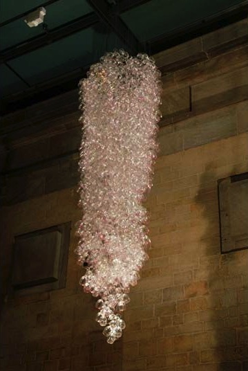 Here Come the Girls 2009

Manchester Art Gallery Atrium

1100 Wine Glasses

Lipstick

Commissioned by Manchester Art Gallery to celebrate the festive season and specifically to link to their exhibition Angels of Anarchy: Women Artists and Surrealism.  The primary reference is to Meret Oppenheim's iconic fur teacup, saucer and spoon, Object.  In a contemporary culture where women are just as likely to drink wine as tea the vessel still functions as a metaphor for the female body, but in the 21st century sexual politics have evolved.

Each glass is individually rimmed with lipstick using the artist's lips.  Cosmetics, particularly lipstick, are often advertised as a way to enhance feminine power and choice, and one cosmetic company even used the slogan 'It's not makeup, it's ammunition'.

<em>"While thinking of 'strong women' femininity, power and Christmastime, I was reminded of the recent Boots TV commercials with crowds of women getting glammed up and marching out to celebrate to the Sugababes 'Here come the Girls'."</em>  Susie MacMurray

The work offers a space for rumination on the evolution of feminism and perceptions of female power/empowerment in it's various guises – cultural/political/sexual.  Also on the different ways women choose to exercise that empowerment (including binge drinking), the ambiguities it throws up, and psychological bargains we strike with ourselves.