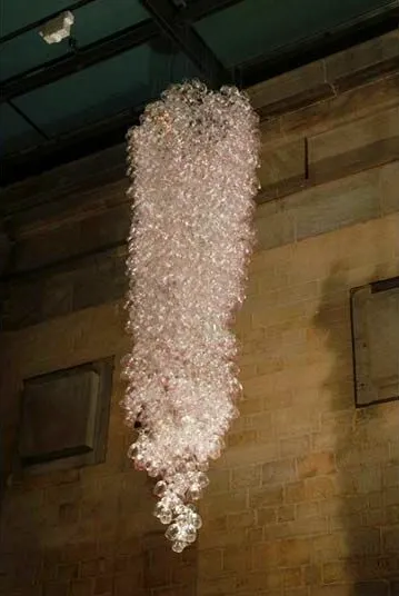 Here Come the Girls 2009

Manchester Art Gallery Atrium

1100 Wine Glasses

Lipstick

Commissioned by Manchester Art Gallery to celebrate the festive season and specifically to link to their exhibition Angels of Anarchy: Women Artists and Surrealism.  The primary reference is to Meret Oppenheim's iconic fur teacup, saucer and spoon, Object.  In a contemporary culture where women are just as likely to drink wine as tea the vessel still functions as a metaphor for the female body, but in the 21st century sexual politics have evolved.

Each glass is individually rimmed with lipstick using the artist's lips.  Cosmetics, particularly lipstick, are often advertised as a way to enhance feminine power and choice, and one cosmetic company even used the slogan 'It's not makeup, it's ammunition'.

<em>"While thinking of 'strong women' femininity, power and Christmastime, I was reminded of the recent Boots TV commercials with crowds of women getting glammed up and marching out to celebrate to the Sugababes 'Here come the Girls'."</em>  Susie MacMurray

The work offers a space for rumination on the evolution of feminism and perceptions of female power/empowerment in it's various guises – cultural/political/sexual.  Also on the different ways women choose to exercise that empowerment (including binge drinking), the ambiguities it throws up, and psychological bargains we strike with ourselves.