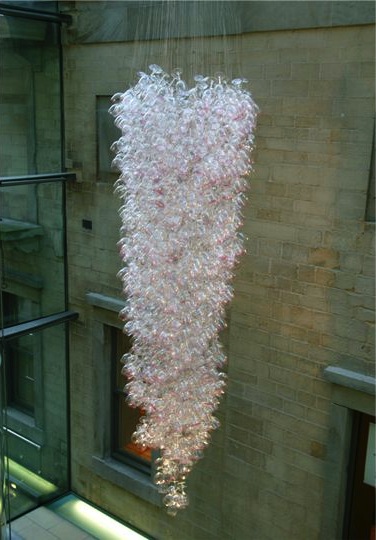 Here Come the Girls 2009

Manchester Art Gallery Atrium

1100 Wine Glasses

Lipstick

Commissioned by Manchester Art Gallery to celebrate the festive season and specifically to link to their exhibition Angels of Anarchy: Women Artists and Surrealism.  The primary reference is to Meret Oppenheim's iconic fur teacup, saucer and spoon, Object.  In a contemporary culture where women are just as likely to drink wine as tea the vessel still functions as a metaphor for the female body, but in the 21st century sexual politics have evolved.

Each glass is individually rimmed with lipstick using the artist's lips.  Cosmetics, particularly lipstick, are often advertised as a way to enhance feminine power and choice, and one cosmetic company even used the slogan 'It's not makeup, it's ammunition'.

<em>"While thinking of 'strong women' femininity, power and Christmastime, I was reminded of the recent Boots TV commercials with crowds of women getting glammed up and marching out to celebrate to the Sugababes 'Here come the Girls'."</em>  Susie MacMurray

The work offers a space for rumination on the evolution of feminism and perceptions of female power/empowerment in it's various guises – cultural/political/sexual.  Also on the different ways women choose to exercise that empowerment (including binge drinking), the ambiguities it throws up, and psychological bargains we strike with ourselves.