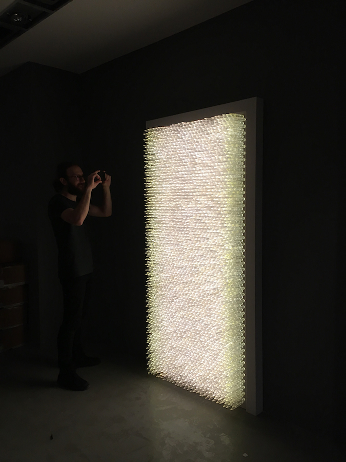 Pandora 2016; LED lightbox within doorframe; clear cast resin 50. cal Browning bullets; installation view, Akbank Sanat, Istanbul 2018