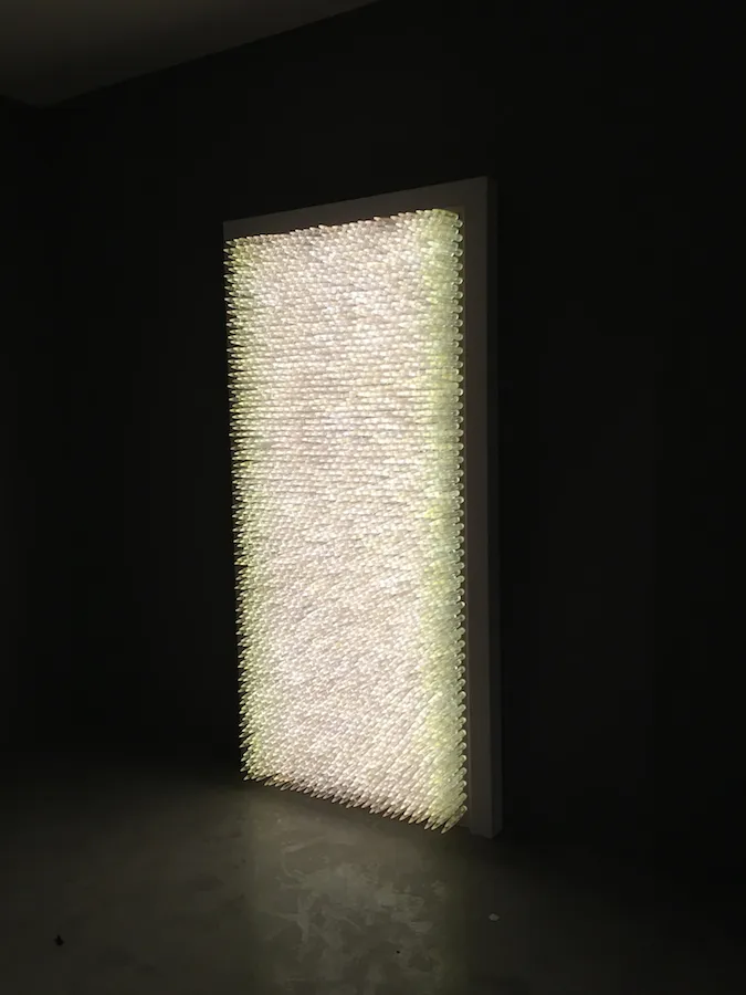 Pandora 2016; LED lightbox within doorframe; clear cast resin 50. cal Browning bullets; installation view, Akbank Sanat, Istanbul 2018