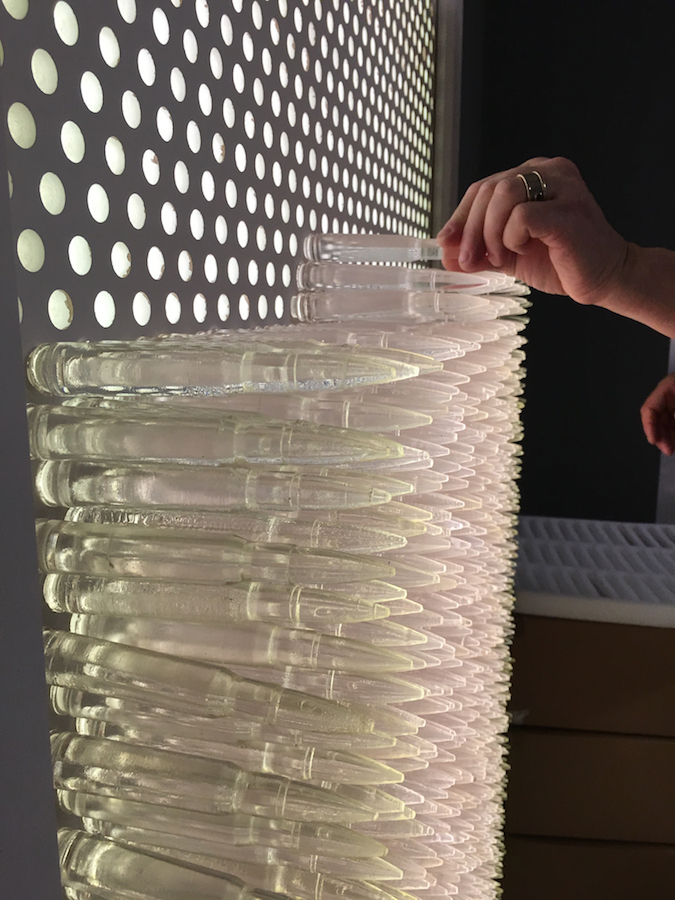 Pandora 2016; LED lightbox within doorframe; clear cast resin 50. cal Browning bullets; installation view, Akbank Sanat, Istanbul 2018