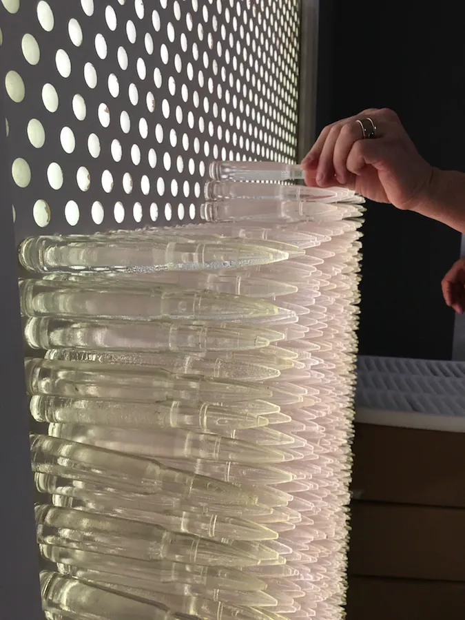 Pandora 2016; LED lightbox within doorframe; clear cast resin 50. cal Browning bullets; installation view, Akbank Sanat, Istanbul 2018